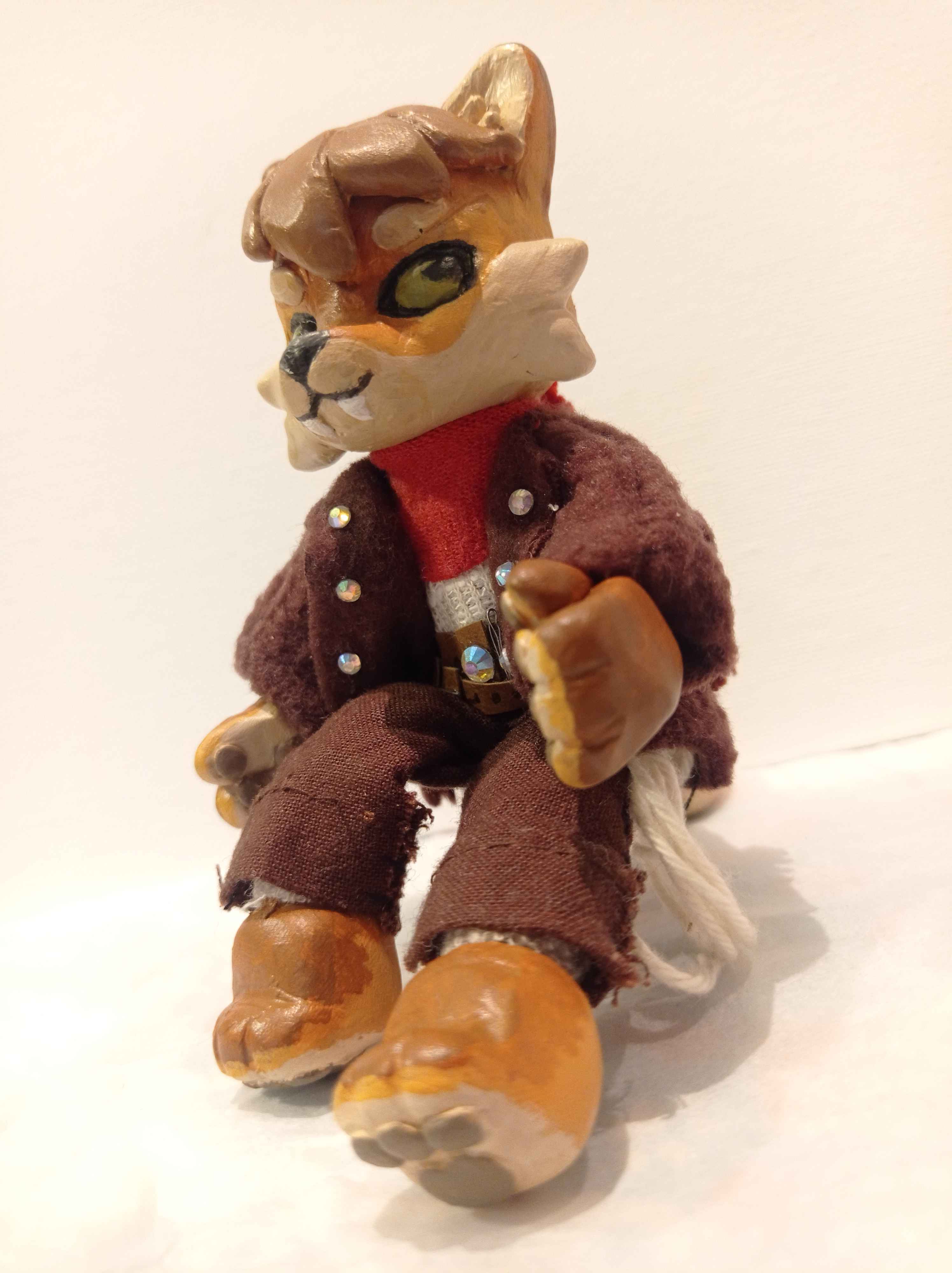 Sculpture of a cream colored anthropomorphic coyote sitting